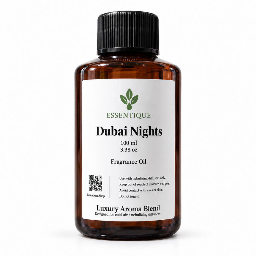 Essentique Dubai Nights 100 mL fragrance oil in
an amber bottle with a black cap and white
front label on a white background.